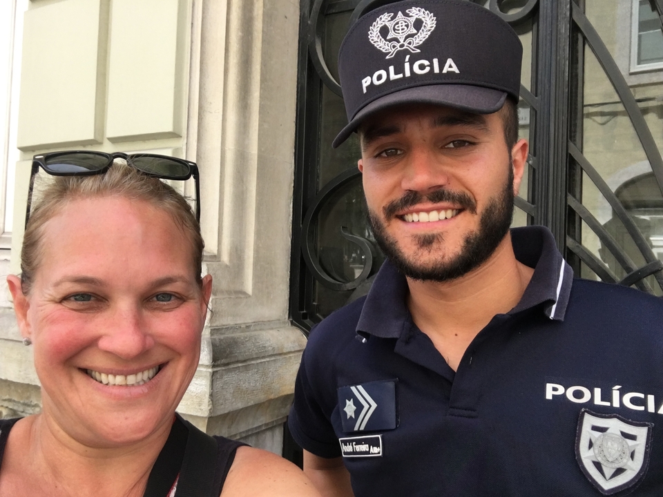Woman with a police officer smiling at the camera.
