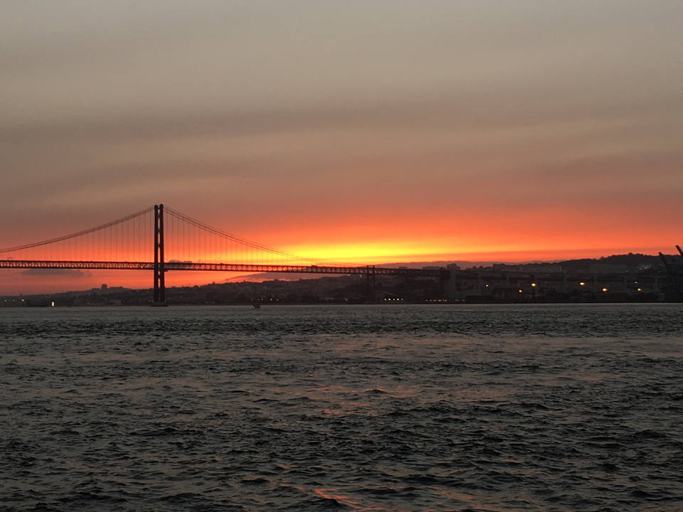 Silhouette d'un pont suspendu pendant un coucher de soleil éclatant.