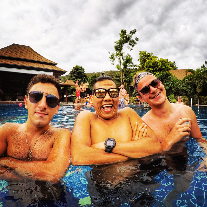 Three people relaxing in a pool.