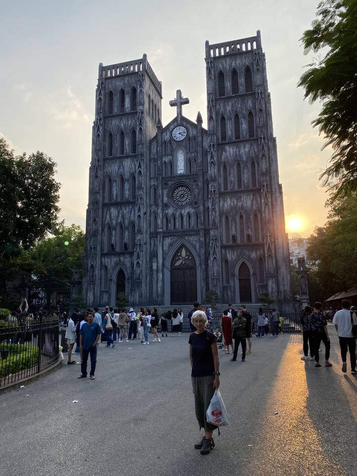 Des gens rassemblés devant une grande cathédrale.