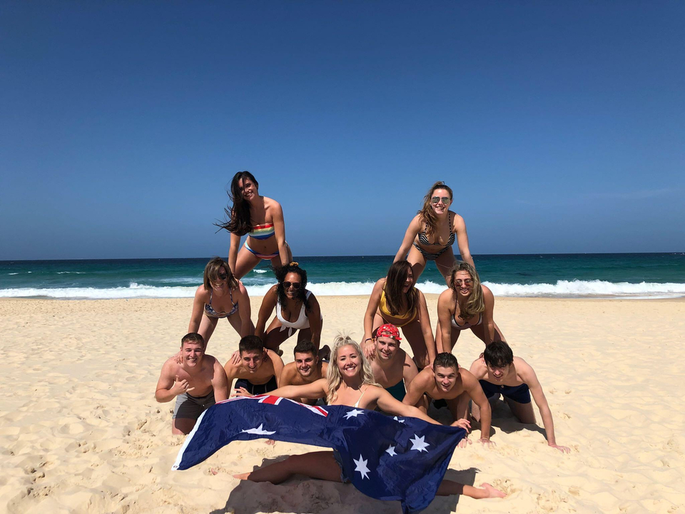 Beach group pyramid holding an Australian flag.