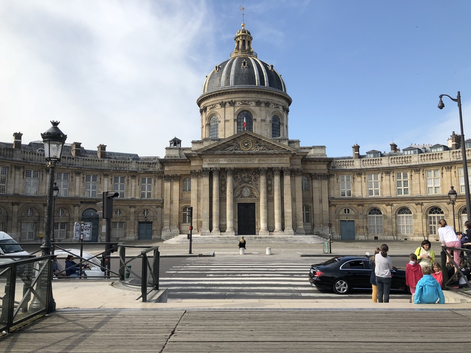 "Palais de l'Institut de France" is already in French. 
If you wanted the English translation, it would be: "Palace of the Institute of France."
The Palais de l'Institut de France is the historic building in Paris that houses the Institut de France, which includes the famous Académie française.