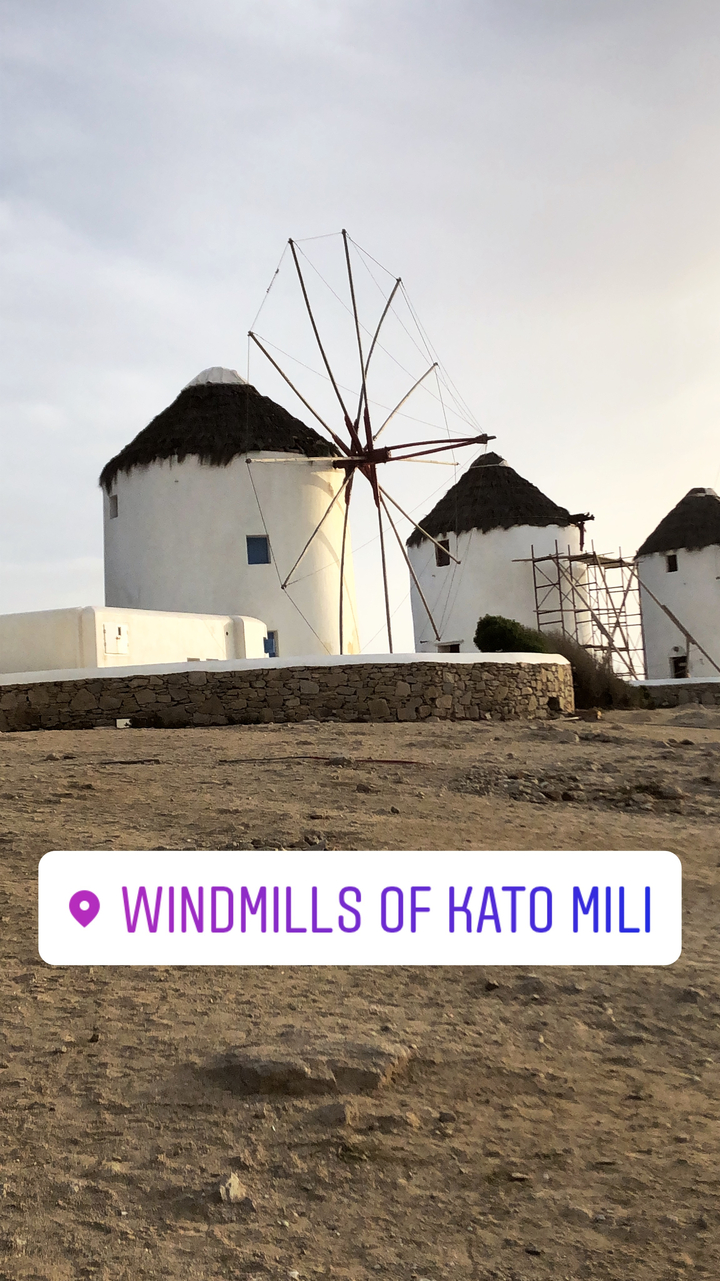 Traditional windmills with whitewashed walls.