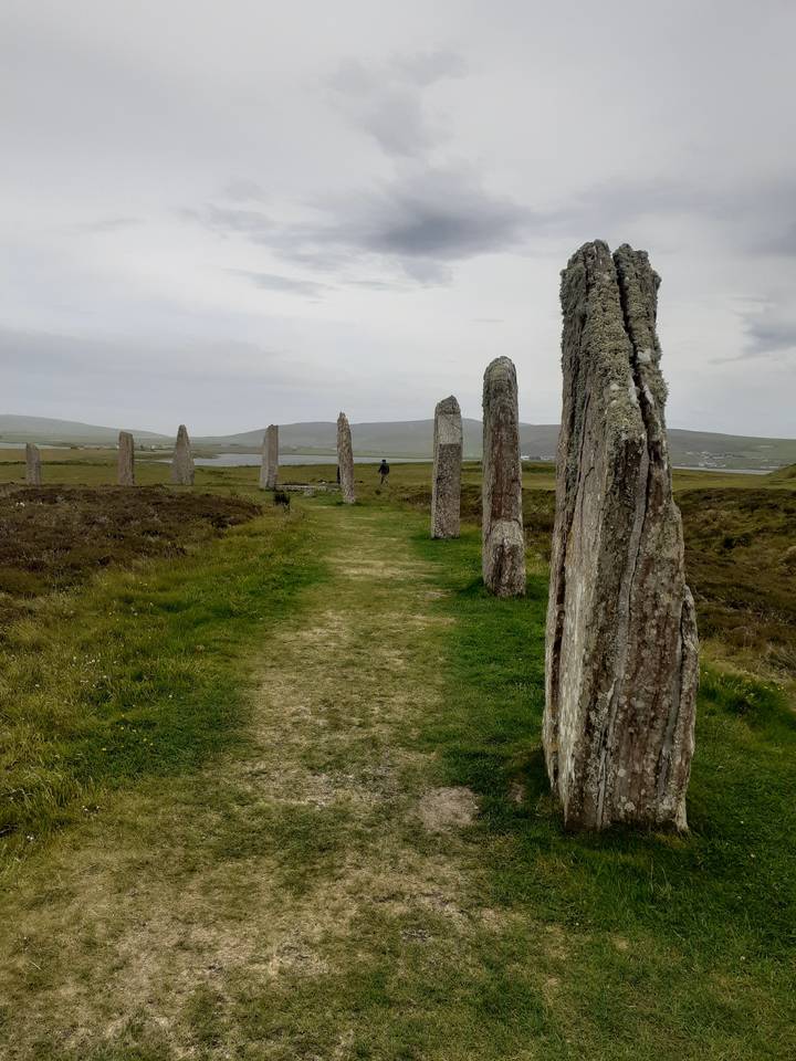 Stone circle standing upright, surrounded by grass.