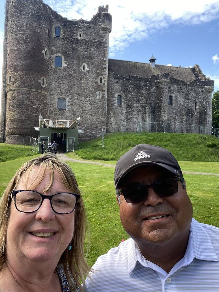 Selfie of a couple in front of a historic castle.