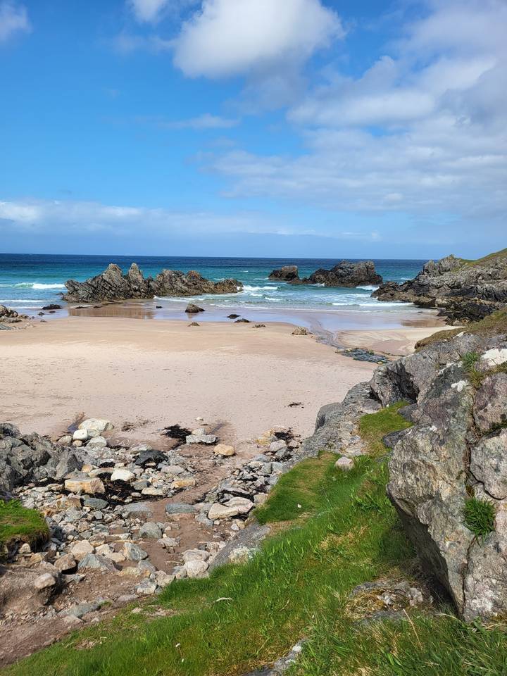 A rocky beach with waves hitting the shore.