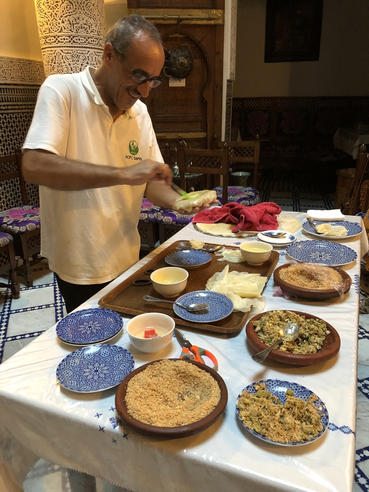 Une personne préparant de la nourriture dans une cuisine de style marocain.