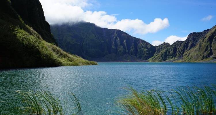 Scenic view of a lake surrounded by mountains.