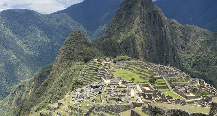 Panoramic view of Machu Picchu with mountains in the background.