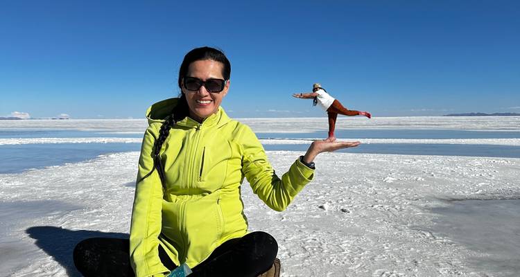 Person at Uyuni Salt Flats performing a perspective trick.
