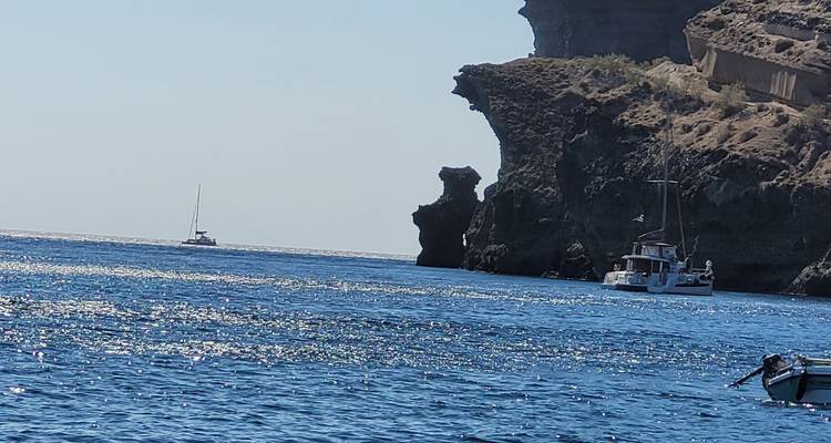 Boat near rocky coastline, scenic view.