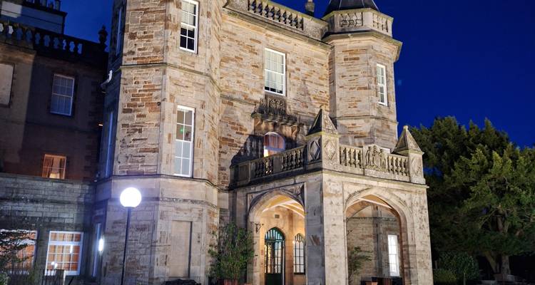 Illuminated stone building at night.