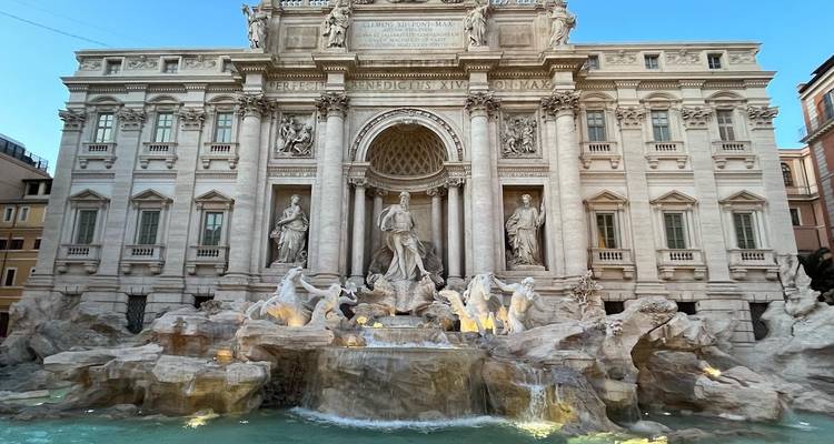 Trevi Fountain with statues and glowing water.