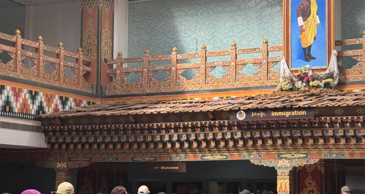 Decorative building interior with people standing in line.