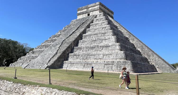 Tourists walking in front of Chichen Itza.