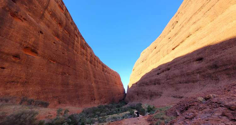 Massive red rock formations under a clear sky.