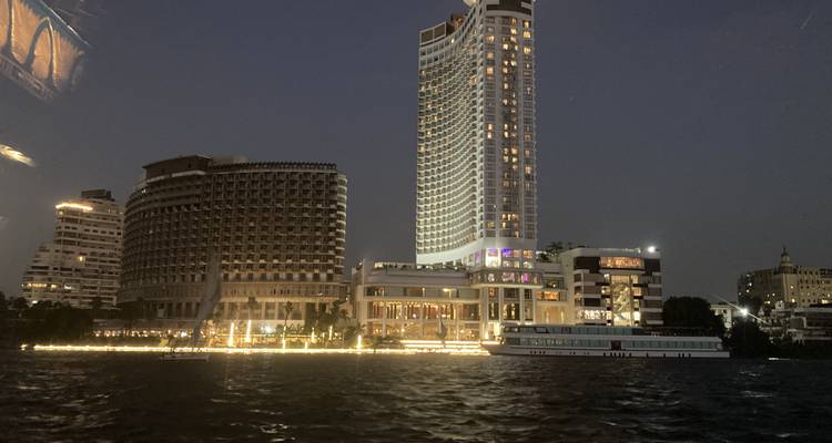 City skyline at night with illuminated buildings.