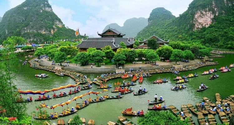 Colorful boats and people in a vibrant festival setting.