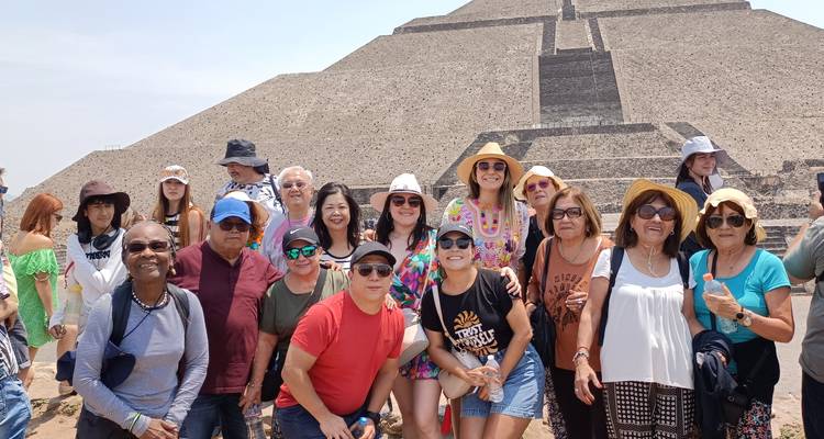 Group posing in front of a pyramid.