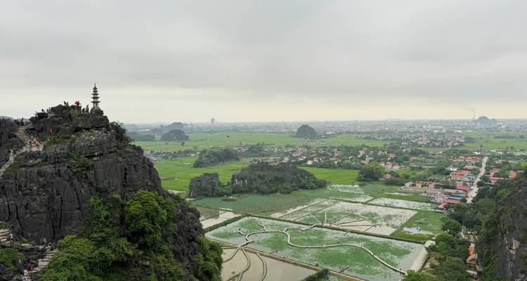 Panoramic landscape view with a pagoda on a mountain.