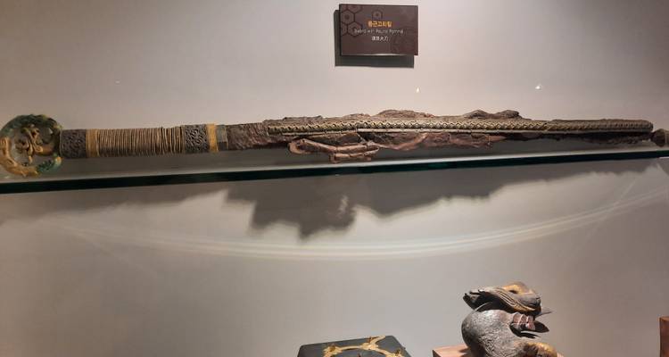 A historical sword displayed in a museum environment with subdued lightning.