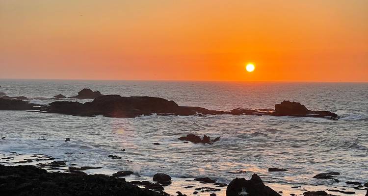 A stunning view of the rocky coastline during sunset.