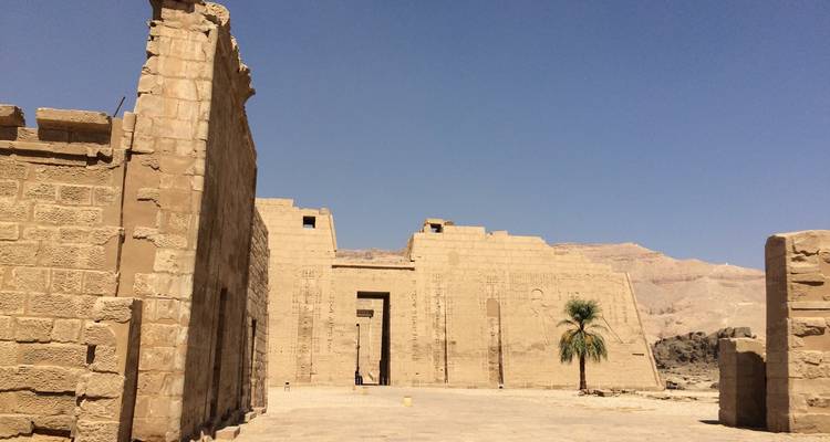 Exterior of a large ancient temple with clear blue sky.