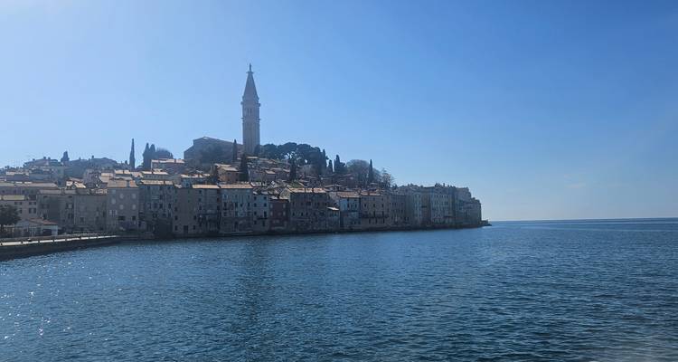 A coastal town with medieval architecture against a clear sky.