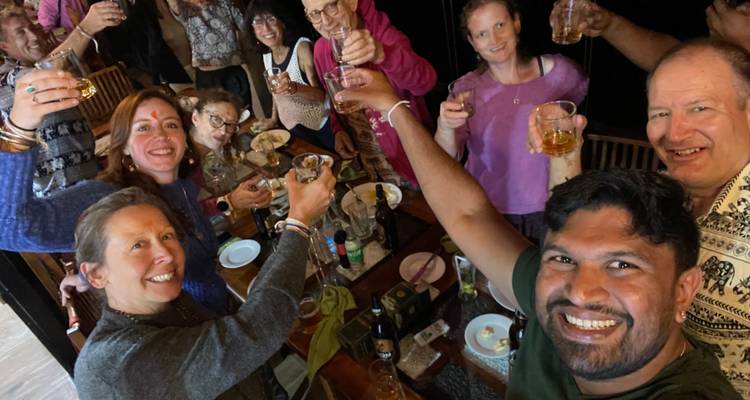 Group of people raising glasses in celebration.