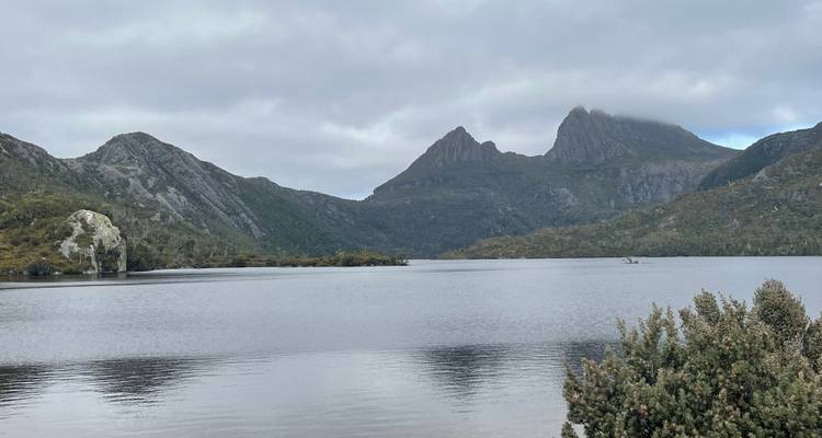 Tranquil lake with mountain backdrop.