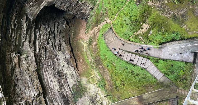Overhead view of a large cave entrance with walkway.