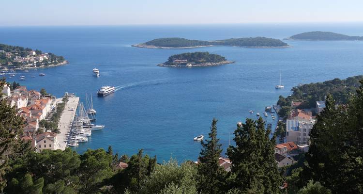 Scenic view of Hvar Island with a port and blue waters.