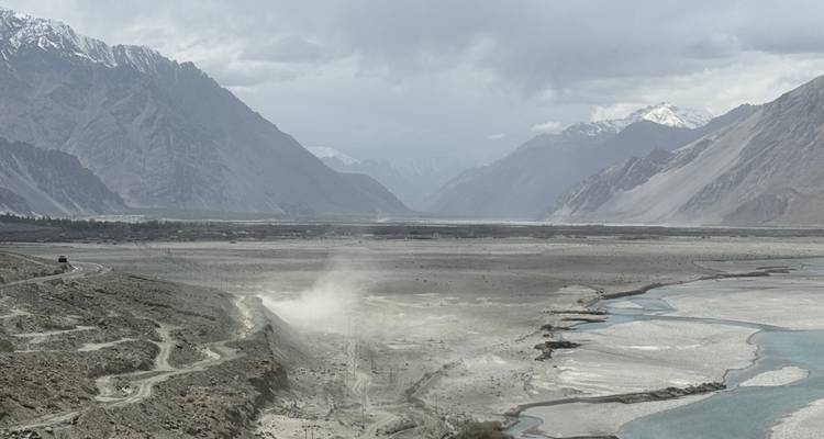 Vast barren valley surrounded by mountains.