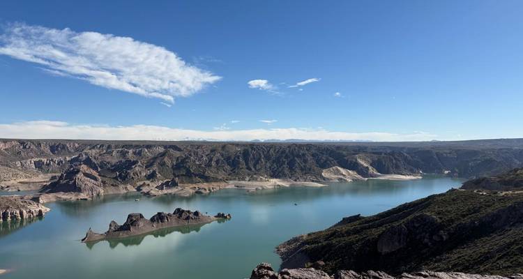 Scenic view of a tranquil lake and the surrounding mountains.