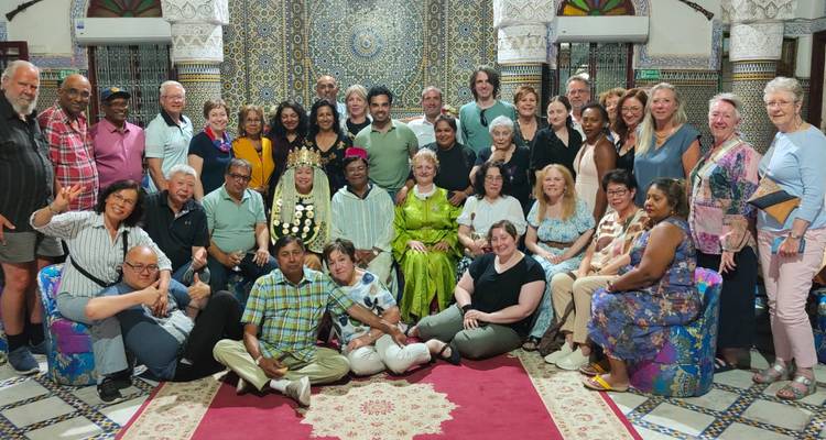 Group gathered in a beautifully tiled room, smiling for the camera.
