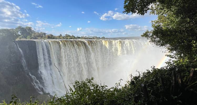 A majestic view of a large waterfall with a rainbow.