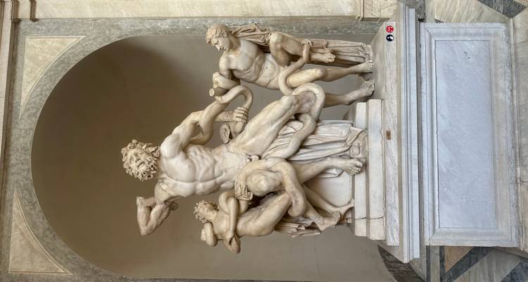 Ancient marble statue in a museum setting.