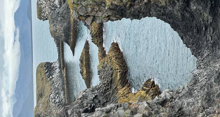 Rugged coastal cliffs with the ocean visible beyond.