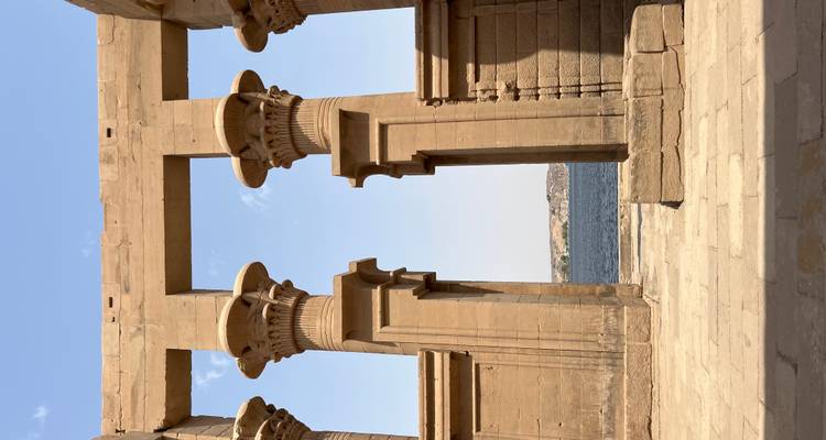 Stone pillars framing a scenic view of a river.