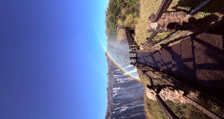 Arc-en-ciel au-dessus d'un sentier menant à la cascade.