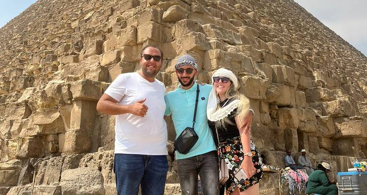 Group of tourists posing in front of the Great Pyramid.