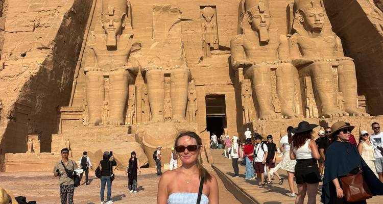 Tourists visiting the Abu Simbel temples with large statues in Egypt.