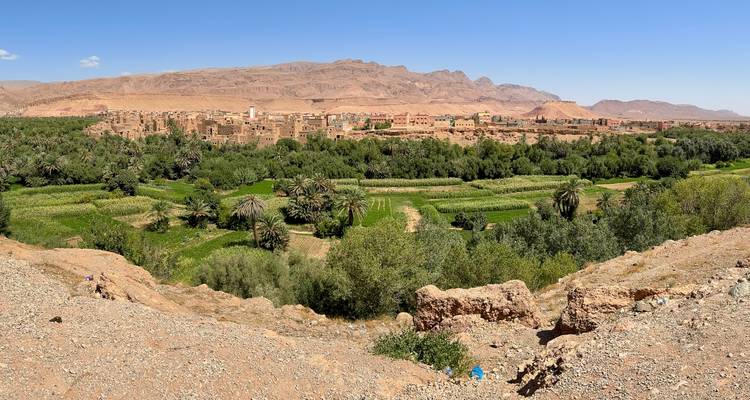 Paysage expansif avec village ancien et végétation luxuriante.