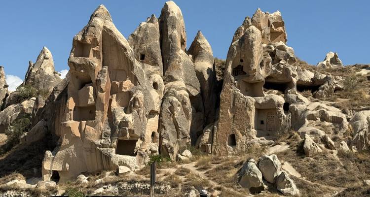 Bizarre rock formations with openings and dwellings carved into them.