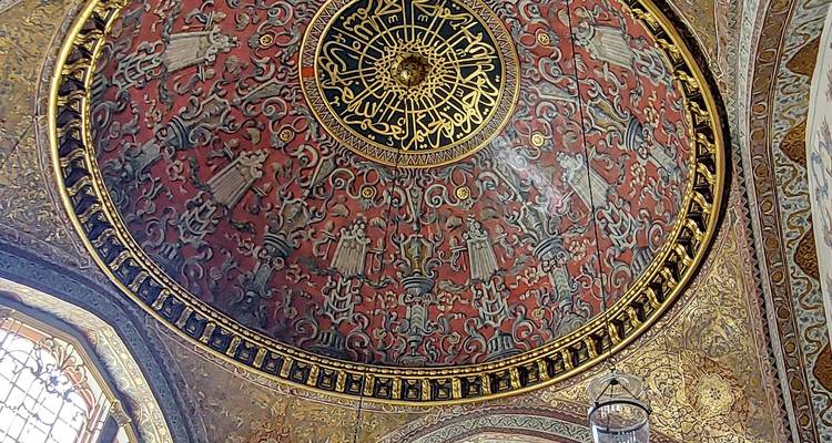 Richly decorated dome interior with intricate patterns.