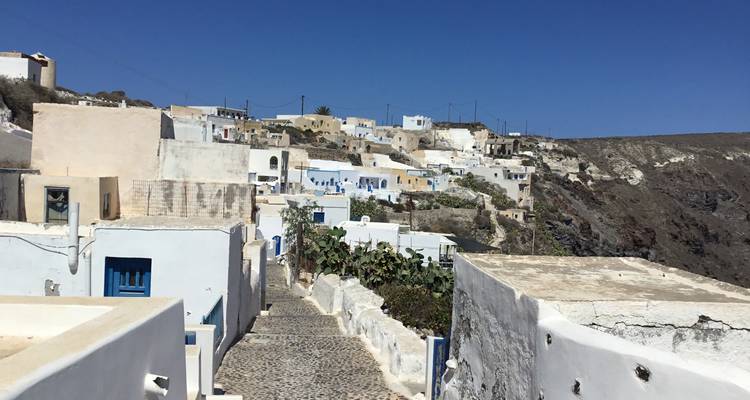 Traditional Greek village with white-washed buildings and blue accents.