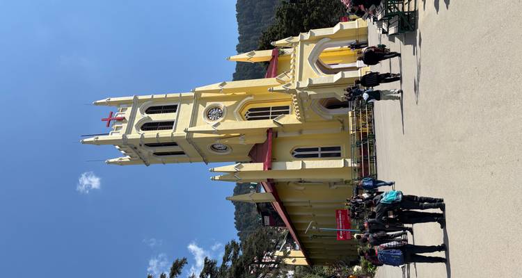 Église jaune avec un toit rouge vue d'en bas