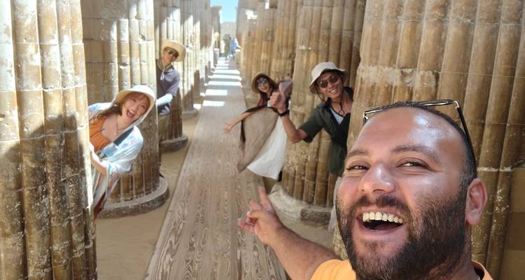 Group of friends peeking from behind columns inside a hall.