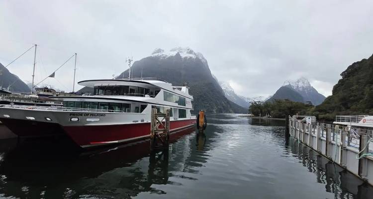 Ferry in a scenic fjord landscape with mountains.