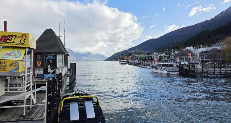 Harbor with boats and mountains in the distance.